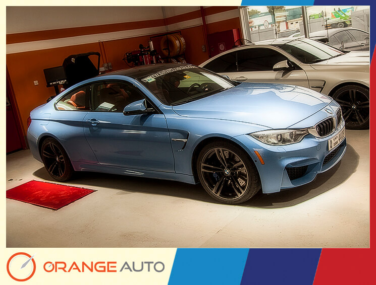 Blue BMW in Orange Auto garage