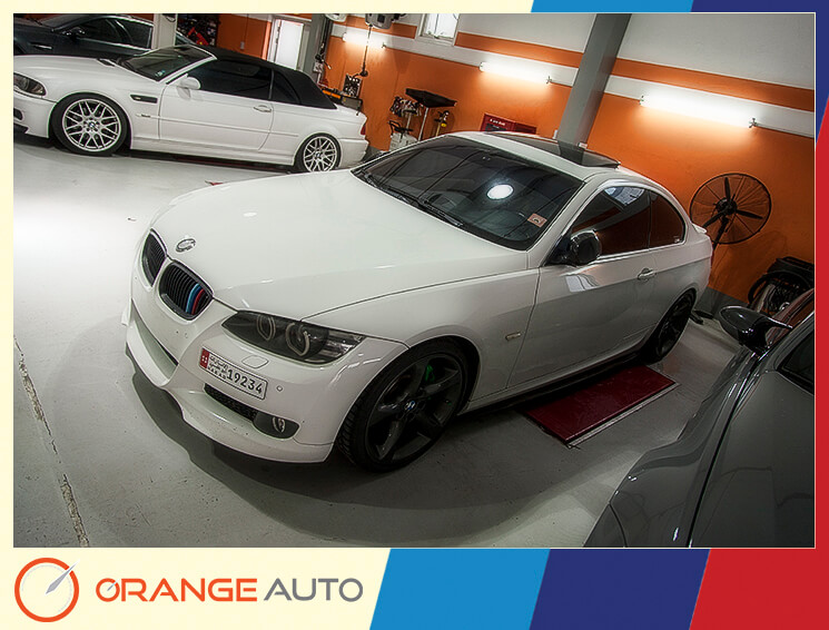 White BMW in Orange Auto garage