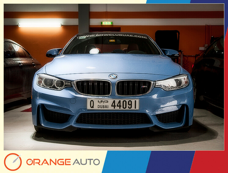 Blue BMW club car in a garage