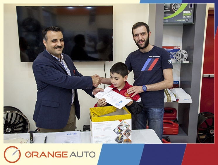 Orange Auto expert center giving a certificate